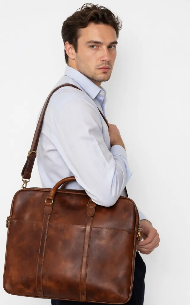 A French male model with a Leather briefcase, wearing a shirt, against a white background, in a front   facing close   up